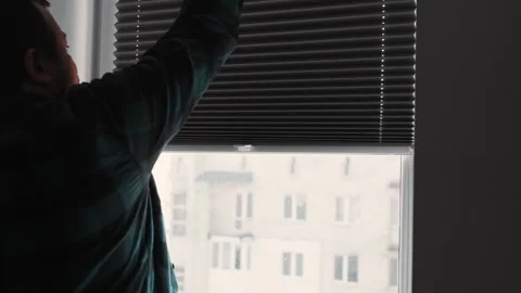 Man installs roller blinds. Handyman mesures window to fix it. Video stock 305343786