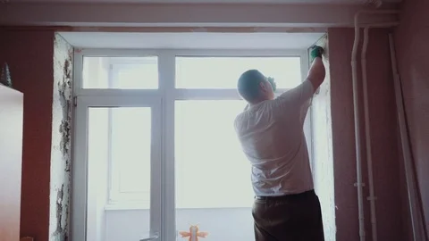 The man installs the windows Stock Footage 81501186