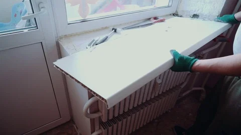 The man installs the windows Stock Footage 81501268