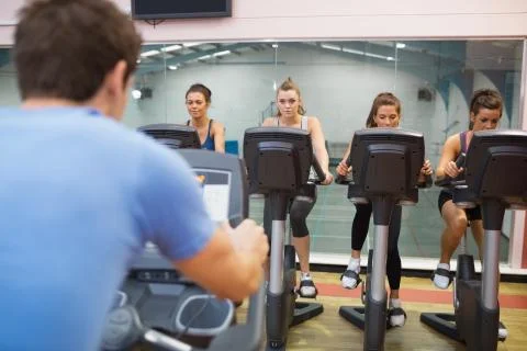 Man instructs spinning class Stock Photos