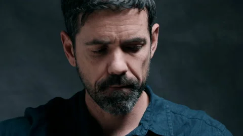 Man with intense look preparing to play a song on guitar Stock Footage 130791535