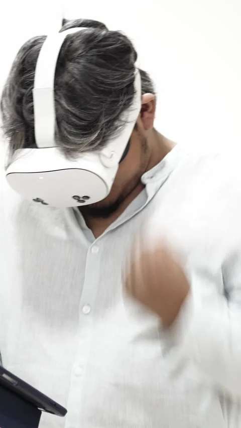 Man interacting with tablet while wearing VR headset Stock Footage 309773107