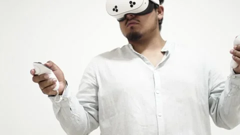 Man interacting with virtual reality headset 스톡 동영상 309772186