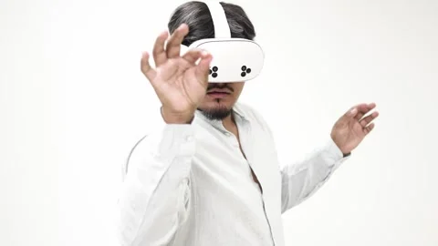 Man interacting with virtual reality headset on white background 스톡 동영상 309772194