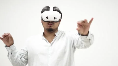 Man interacting with virtual reality headset on white background 스톡 동영상 309772307
