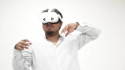 Man interacting with virtual reality headset 스톡 동영상 309772308