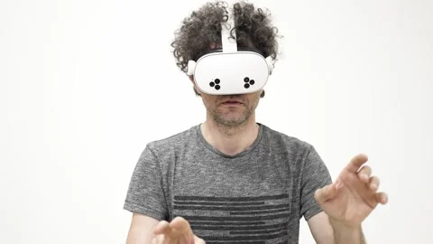 Man interacting with virtual reality headset 스톡 동영상 309772416