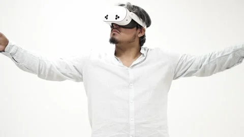 Man interacting with virtual reality headset, isolated on white background 스톡 동영상 309772474