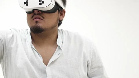 Man interacting with virtual reality headset 스톡 동영상 309772475