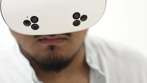 Man interacting with virtual reality headset on white background Stock Footage 309772591