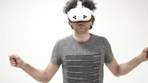 Man interacting with virtual reality headset on white background 스톡 동영상 309772640