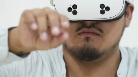 Man interacting with virtual reality headset on white background 스톡 동영상 309772981