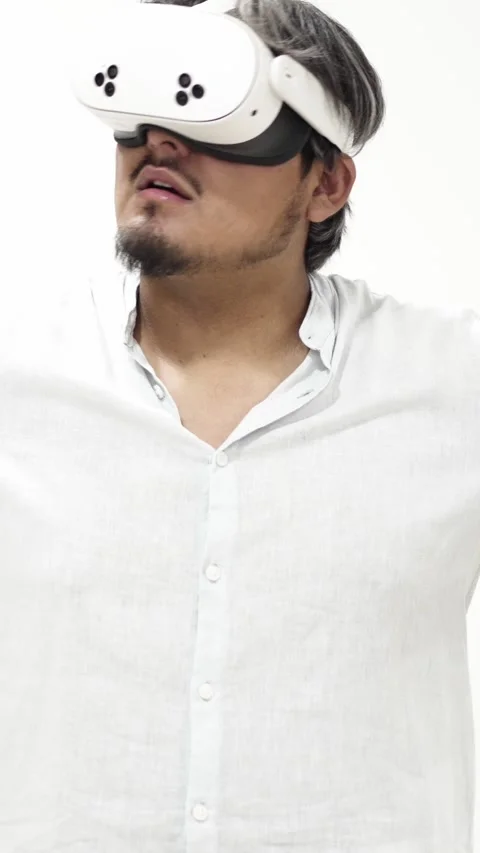 Man interacting with virtual reality headset on white background 스톡 동영상 309773059