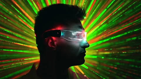 The man in interactive glasses on a colorful rays background Stock Footage 191498396