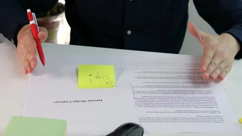 Man with interior design contract and sticky notes with handwritten notes Stock Footage 312603766