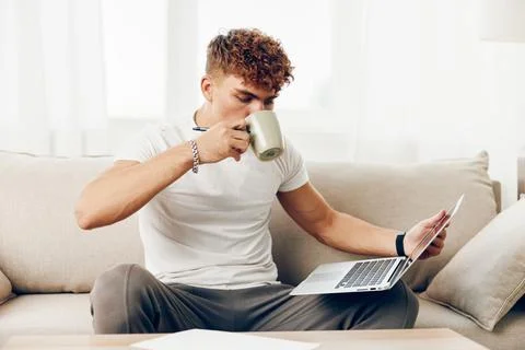 Man interior education using sofa person t-shirt caucasian internet adult Stock Photos