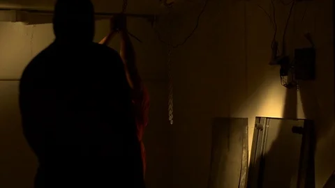 Man interrogated while dangling Stock Footage 129264118