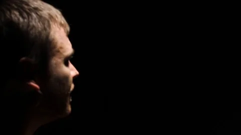 A man is in interrogating as the camera moves around him. Stock Footage 99611983