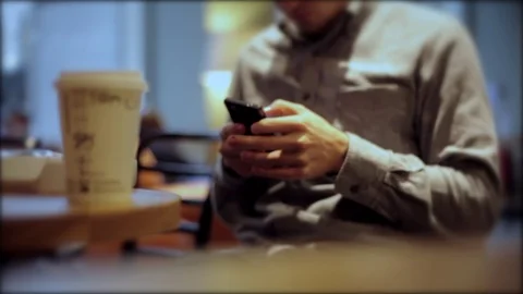 Man on iPhone, Smartphone with Coffee Hands texting twitter facebook instagram Stock Footage 81843619