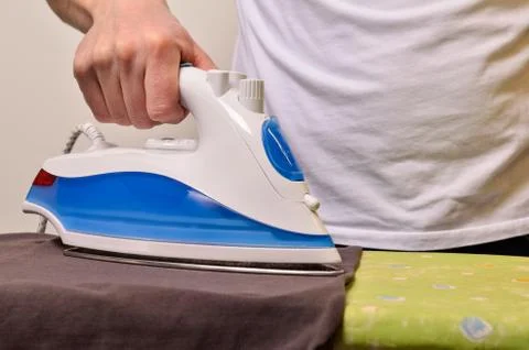 Man with an iron Stock Photos