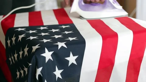 Man irons the flag of the USAmerica on the table. Stock Footage 236295933