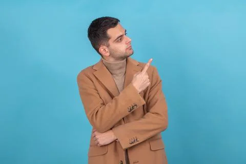 Man with isolated coat pointing Foto stock
