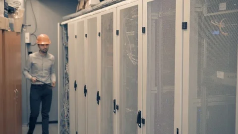 Man IT Engineer In Helmet Working In Server Room.Technical Engineer Working. 库存影片 104198733