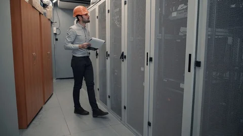 Man IT Engineer In Helmet Working In Server Room.Technical Engineer Working. 库存影片 104199263