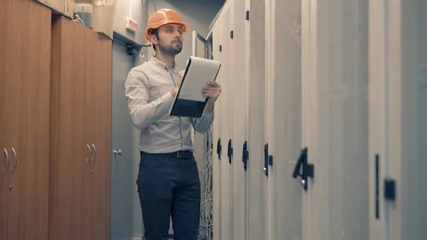 Man IT Engineer In Helmet Working In Server Room.Technical Engineer Working. 库存影片 104199349