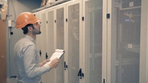 Man IT Engineer In Helmet Working In Server Room.Technical Engineer Working. 库存影片 104199379