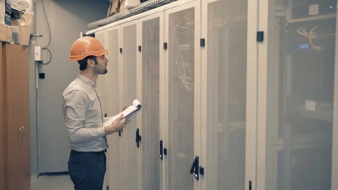 Man IT Engineer In Helmet Working In Server Room.Technical Engineer Working. 库存影片 104199395