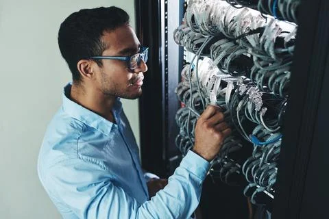 Man, IT technician and checking cables in mainframe for troubleshooting, storage Stock-Fotos
