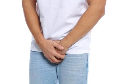 Man with itching crotch on white background, closeup Stock Photos