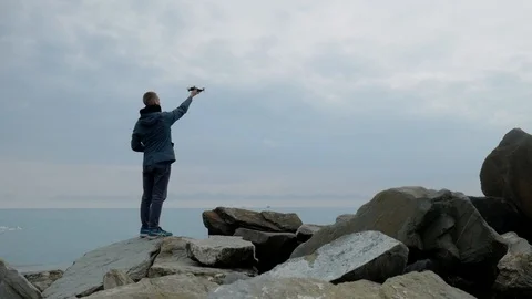 Man in the jacket is back and runs the drone. Stock Footage 104869313