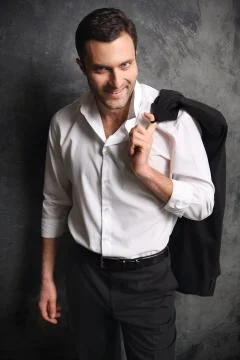 A man with a jacket on a black background Stock Photos