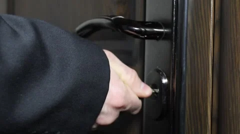 A man in a jacket closes the door key Stock Footage 59726349
