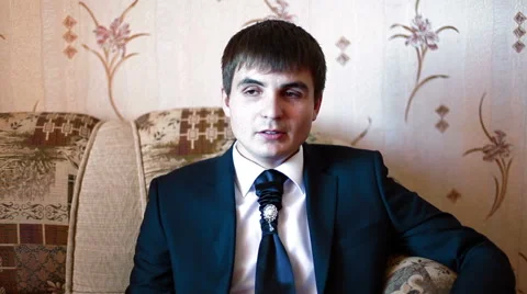 Man in a jacket gives interviews on camera Stock Footage 60004478