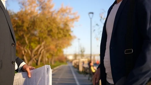 A man in a jacket with important documents in his hand, shakes his hand. HD Stock Footage 114601397