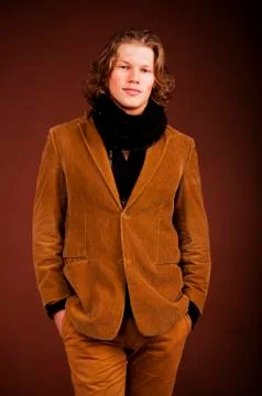 Man in  jacket  isolated on brown background Stock Photos