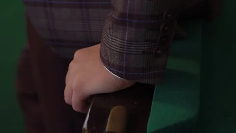 Man in a jacket leaning on a chair close-up Stock Footage 306173897