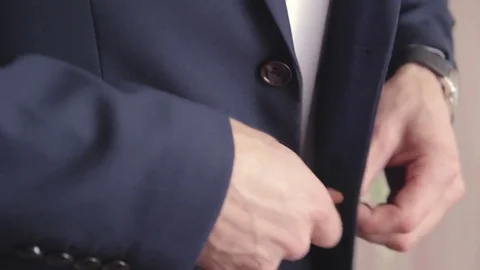 A man in a jacket on a light background, a groom's fees Stock Footage