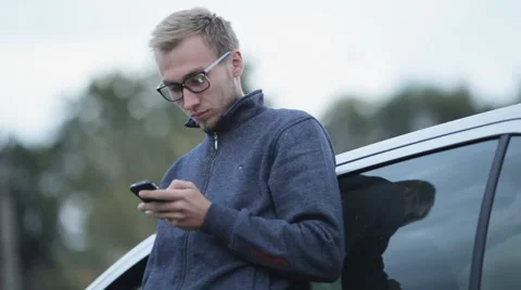 A man in a jacket near the machine dials the message Stock Footage 55334583