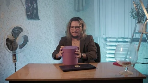 A man in a jacket opened a box with keys in an empty room 스톡 동영상 200829618