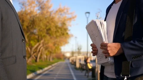 A man in a jacket passes important documents into the hands of a partner. HD Stock Footage 114601390