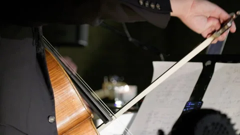 A man in a jacket playing cello. Stock Footage 273809651