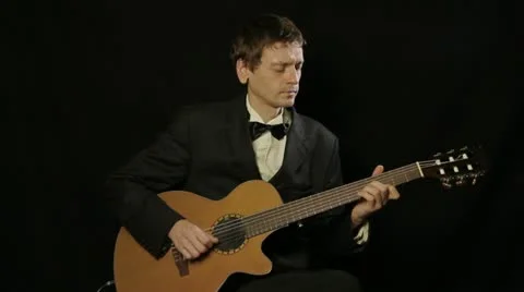 Man in jacket playing a guitar Video stock 14878018