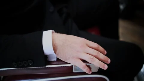 The man in the jacket put his hand on the armrest Video stock 328370416