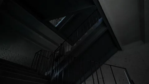 A man in a jacket quickly descends the stairs down in the apartment Stock Footage 205324583