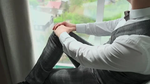 A man in a jacket sits by the window Video stock 328183985