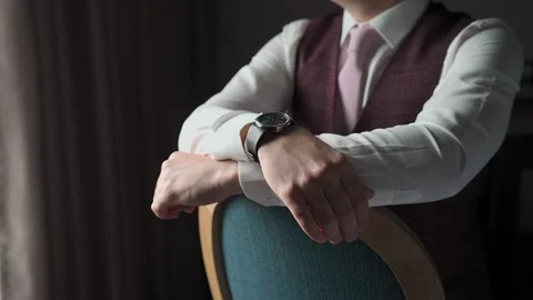 A man in a jacket sits by the window Stock Footage 328299463